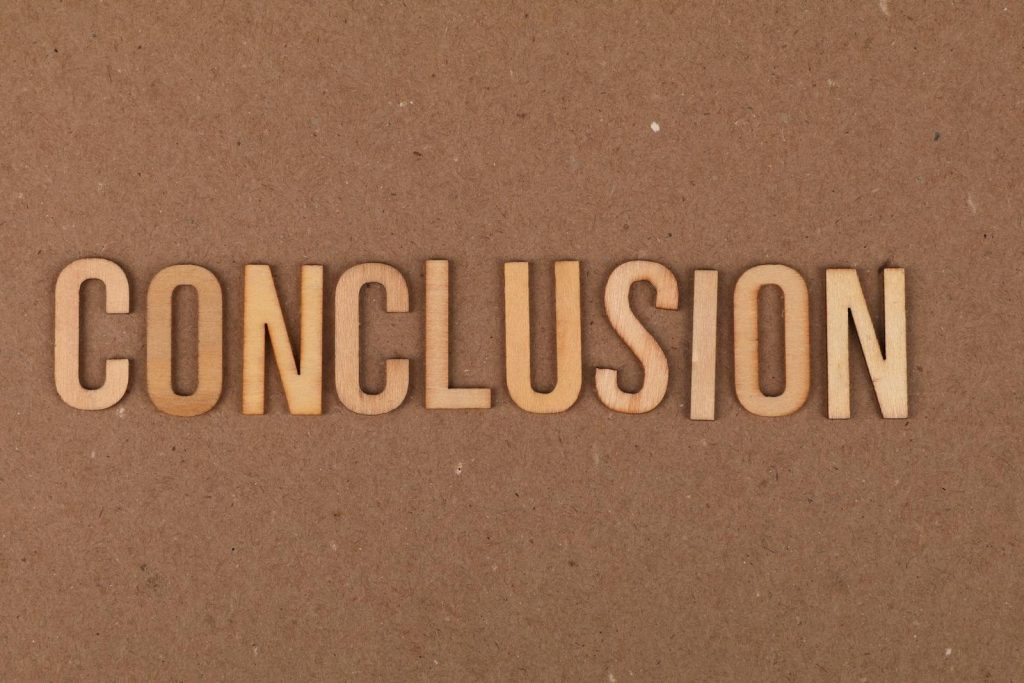 Wooden letters arranged to spell 'Conclusion' on a brown cardboard background.