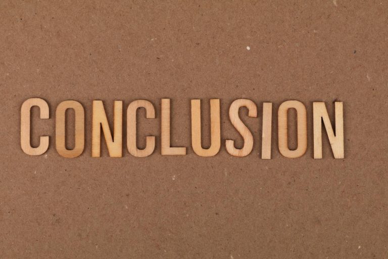Wooden letters arranged to spell 'Conclusion' on a brown cardboard background.